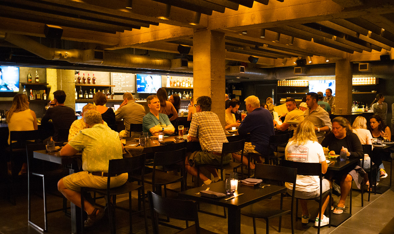 patrons at tables in bar